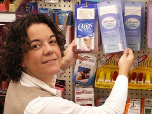 Person looking at different brands of cotton swabs in a store